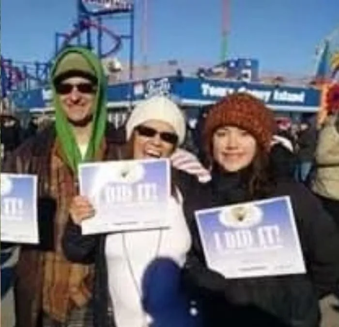 Isa Herrera and her family at the Coney Island Polar Bear Plunge, holding signs that read I DID IT.